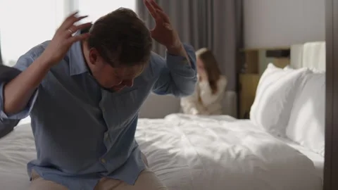 Angry husband shouting and gesturing emotionally at his crying wife in the Stock Footage 337120322