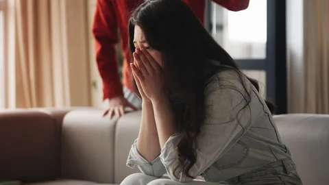 Angry husband shouting at upset crying Asian woman, gaslighting, quarrel Stock Footage 330401984