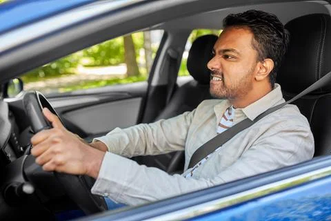 Angry indian man or driver driving car Stock Photos