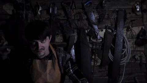 Angry insane maniac with a rusty sledgehammer in an old house. copy space 動画素材 136442910