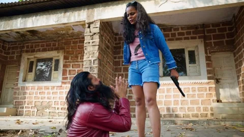 Angry lady cop confront bearded criminal kneeling outdoor Stock Footage 303962494