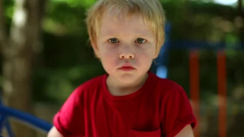 Angry little boy talking looking at camera with interested eyes enjoying 스톡 동영상 147034591