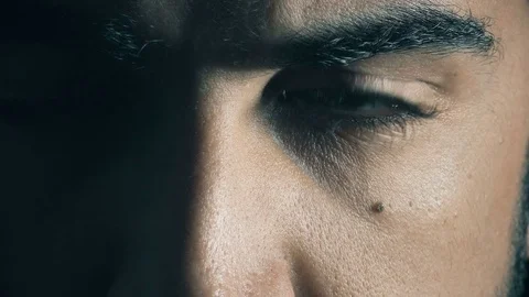 Angry look of 30 year old latin  man in the darkness Stock Footage 74689042