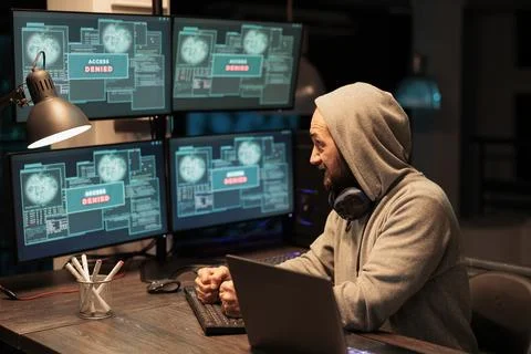 Angry mad hacker punching keyboard after failing to hack Foto stock