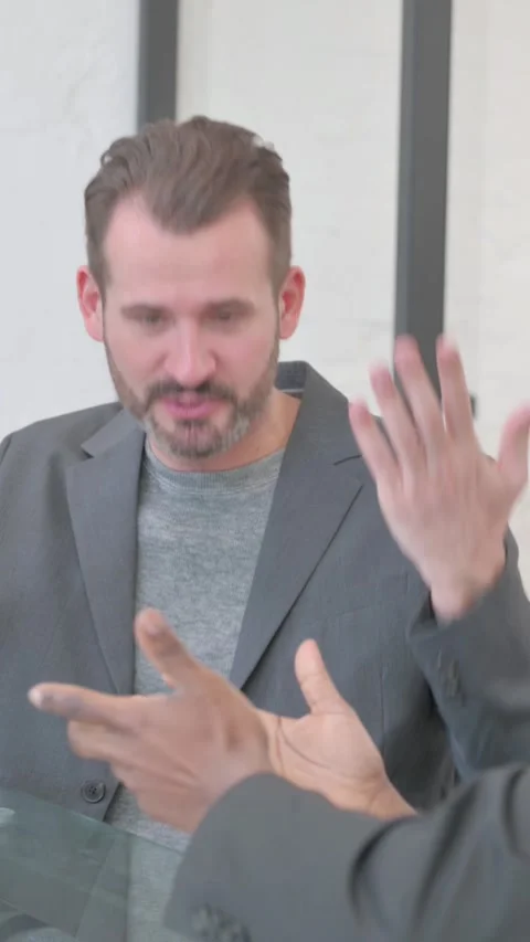 Angry Man in Argument with African Colleague, vertical video Stock Footage 324698317