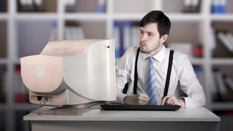 Angry man is beating old computer with hand in office. Video stock 157057616