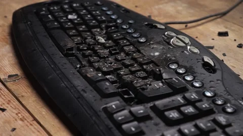 Angry man breaks the keyboard with a hammer Stock Footage 136779986