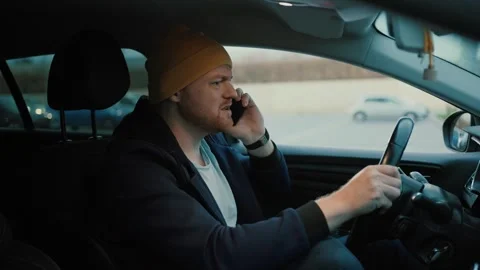 Angry man driver speaking on smartphone on highway Stock Footage 265291486