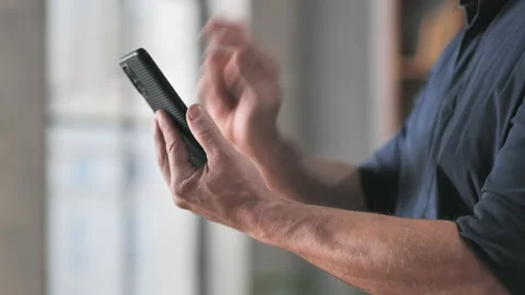 Angry man hand beating hitting broken phone Stock Footage 229297132