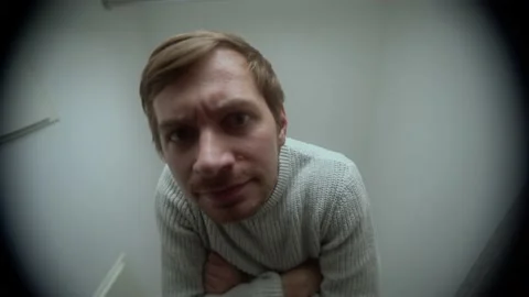 An angry man knocks on the door. View through the peephole Stock Footage 152733289