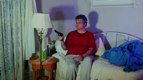 Angry man looking at a pistol Stock Footage 95152676