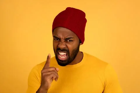 Angry man pointing to the camera while screaming to someone. Stock Photos