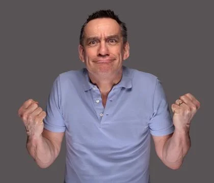 Angry man pulling face and shaking fists Stock Photos