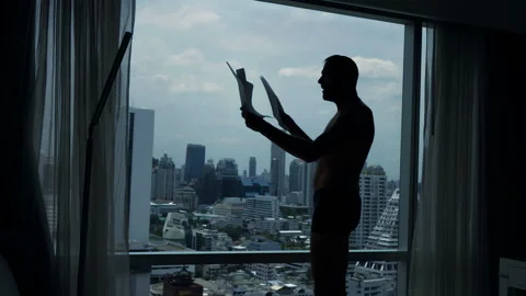 Angry man reading documents by window at home, super slow motion Vídeo Stock 108174409