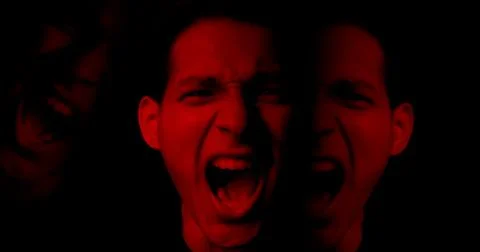 Angry man scream in red light. Aggression mental anger. Split mind concept. Stock Photos
