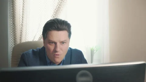 Angry man screaming while working at the computer Stock Footage 169648565