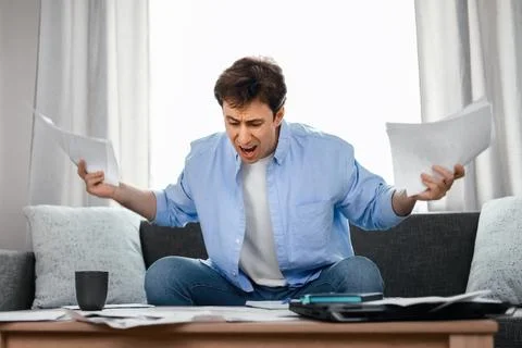 Angry man shouting in despair over high utility bills and expenses. Inflati.. 写真素材