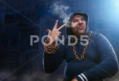 Angry man, sitting with a cigarette Stock Photos