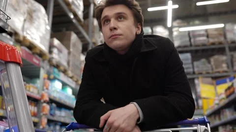 An angry man is standing in line at a supermarket with a cart Stock Footage 150851053