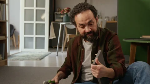 Angry Man Swearing at Mistake while Assembling Flatpack Locker Stock Footage 330512352