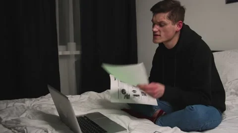Angry man talking by video chatting on laptop in bedroom. Aggressive manager Stock Footage 148385047