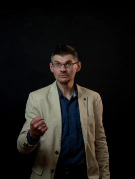 Angry man with tree-day stubble shows fist on studio stage Stock Photos