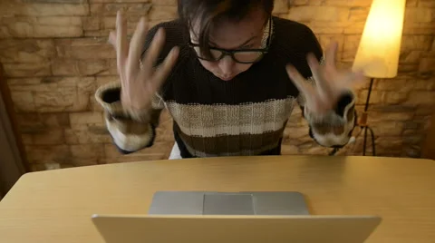 Angry man using laptop computer Stock Footage 68633869