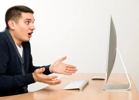 Angry man yelling on computer screen Stock Photos