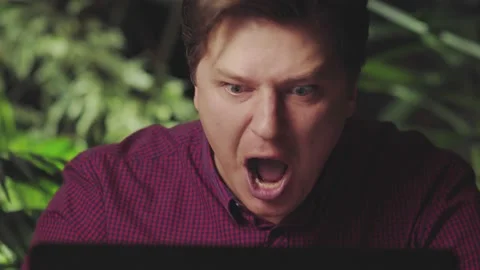 Angry man yells while working at the computer Stock Footage 150149780