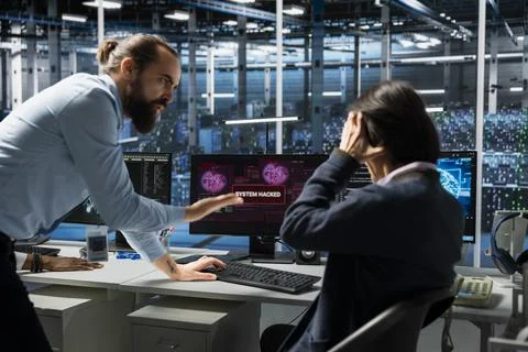 Angry manager berating engineer in server hub for letting hacker steal data Stock Photos