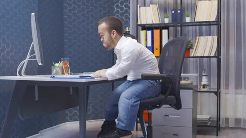Angry midget man working on computer in his office. Video stock 230980394