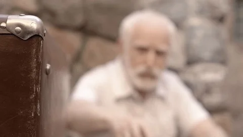 Angry NKVD soldier interrogates a miserable, bearded, gray-haired old man on the Stock Footage 100372566