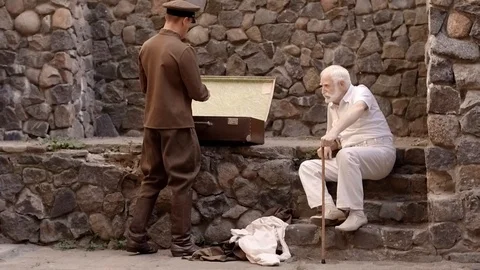 Angry NKVD soldier interrogates a miserable, bearded, gray-haired old man on the Video stock 100372585