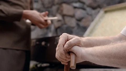 Angry NKVD soldier interrogates a miserable, bearded, gray-haired old man on the Stock Footage 100372588