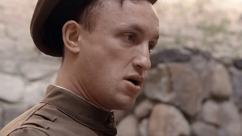 Angry NKVD soldier interrogates a miserable, bearded, gray-haired old man on the Video stock 100372596