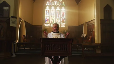 Angry priest talking about something in church Stock Footage 262295877