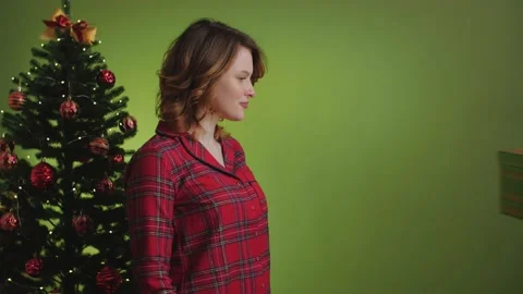 Angry scared girl refusing a gift fighting on green background. Fun scene Stock-Footage 165460510