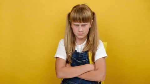 Angry schoolgirl, crossed arms looking to side, does not want to go to school Stock Footage 160103953