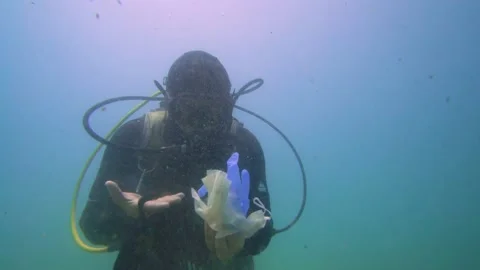 Angry Scuba Diver Shows the Single Use Trashes Underwater Stock Footage 144896549