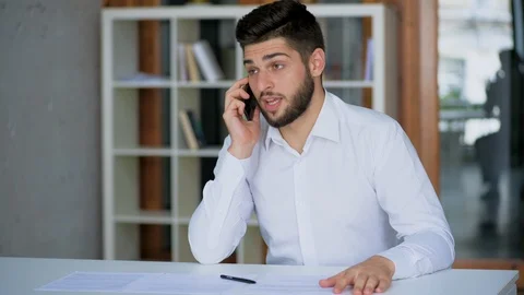 Angry stressed out man talking on the phone with business clients wearing whi Stock Footage 124368905