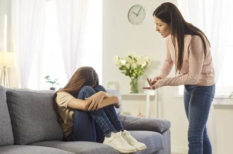Angry strict mother lecturing her naughty daughter, yelling and scolding small Stock-Fotos