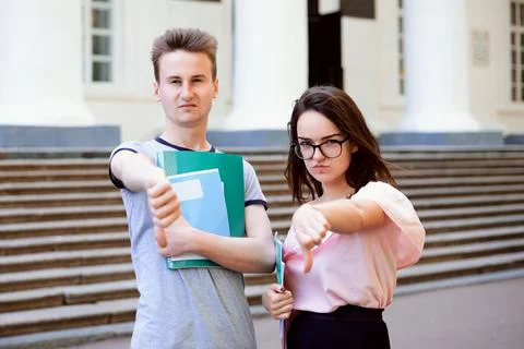 Angry students showing thumbs down Stock Photos