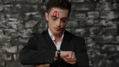 Angry vampire checks the time with frustration Stock Footage 311815484