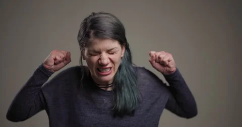 Angry woman with expressive face pulling hair in frustration Stock Footage 341517787