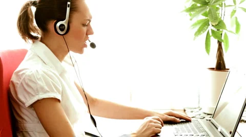 Angry woman with headphones screaming at laptop Stock Footage