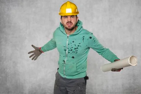 An angry worker with construction plans Foto stock
