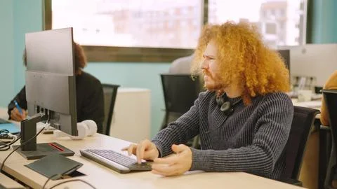 Angry worker experiencing computer problems in a coworking Stock Photos