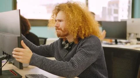 Angry worker experiencing computer problems in a coworking Stock Photos