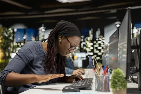 Angry worker in Silicon Valley startup office hitting desk in frustration Stock Photos