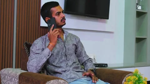 Angry young Indian man gesturing and shouting while talking on a smartphone Stock-Footage 330390857